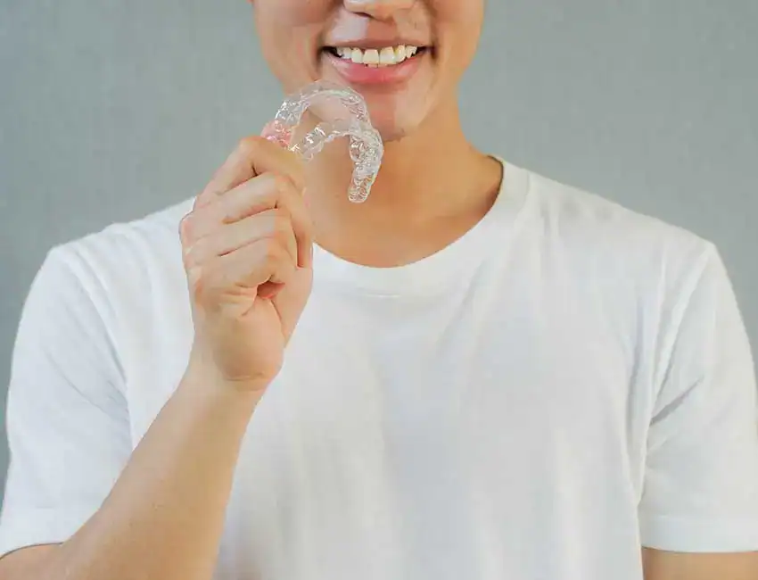 Patient holding mouthguards at The Smile Spa