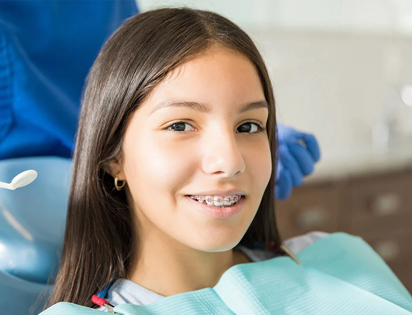 Dentist putting patients new braces at The Smile Spa