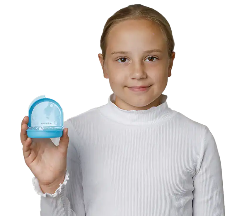 A child holding an Invisalign First aligner at The Smile Spa