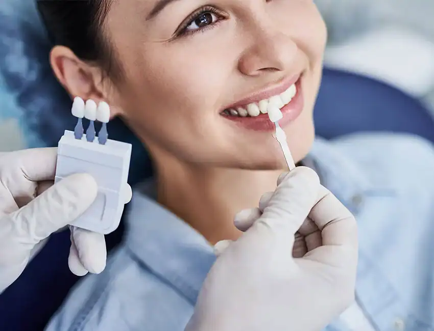 Patient smiling at her nearby dentistry